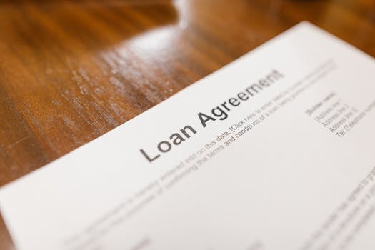 courses-01-free-img Detailed loan agreement document close-up on a wooden table representing legal and financial concepts.